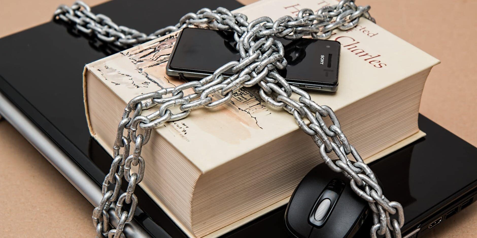 black android smartphone on top of white book