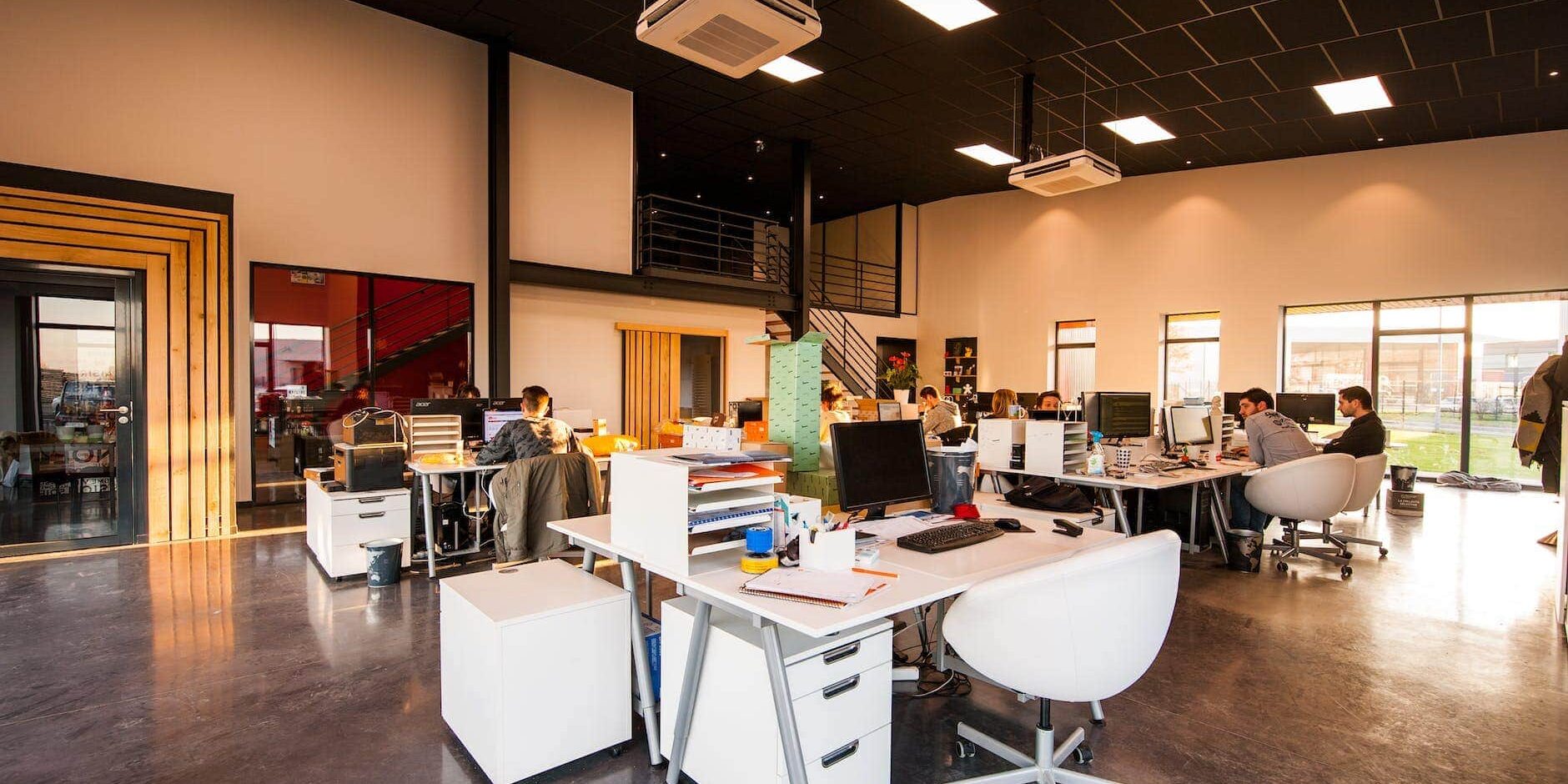 people sitting on chairs beside their desks in an office