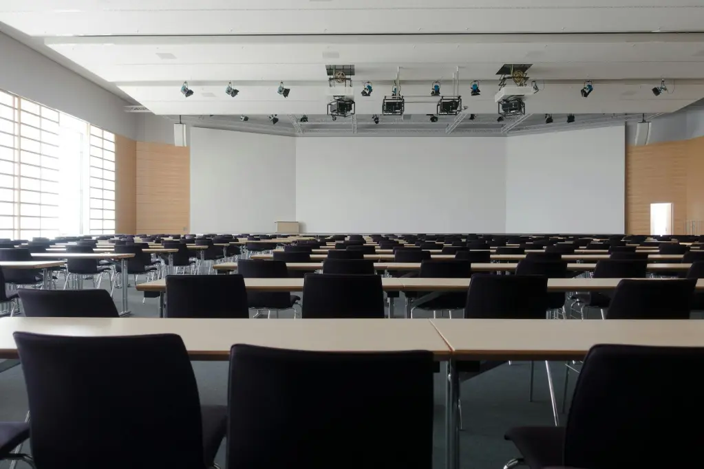 Empty conference room with large whiteboard and projectors